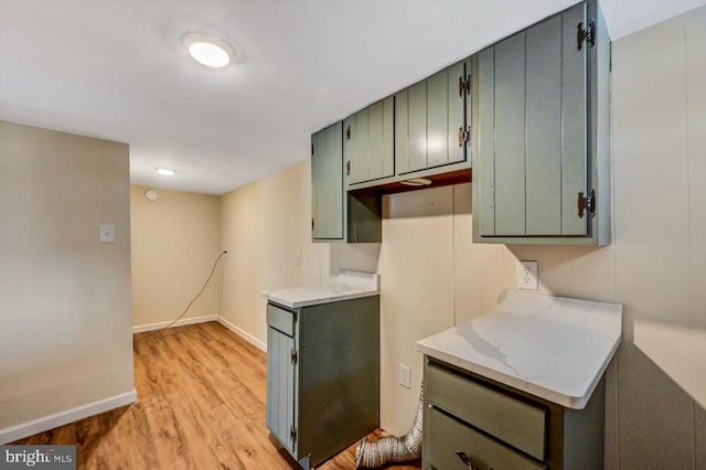 kitchen with green cabinetry and light hardwood / wood-style floors