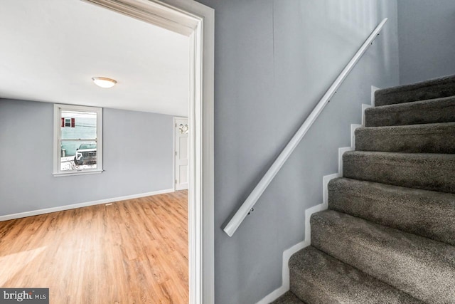 stairs with wood-type flooring