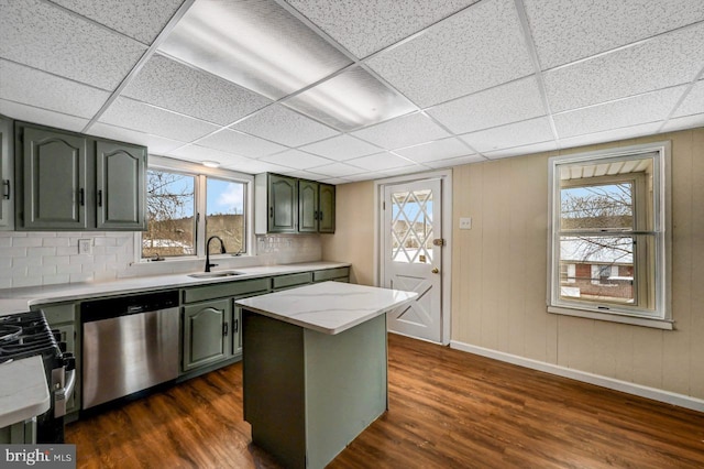 kitchen featuring green cabinets, decorative backsplash, sink, dark wood-type flooring, and stainless steel appliances