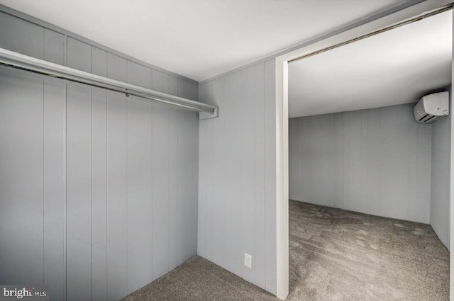 walk in closet featuring light colored carpet and a wall unit AC