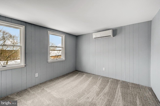 carpeted empty room with plenty of natural light and a wall mounted air conditioner