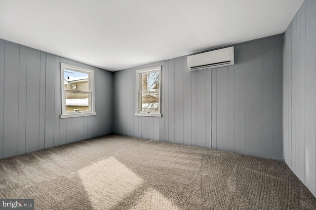 carpeted empty room with a wall mounted AC and wooden walls