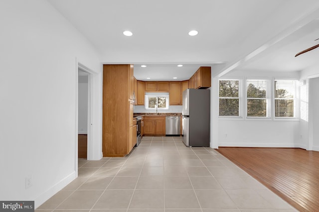 kitchen featuring light tile patterned flooring, ceiling fan, stainless steel appliances, and sink