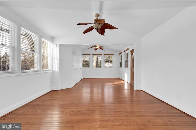 unfurnished room featuring wood-type flooring, ceiling fan, and vaulted ceiling