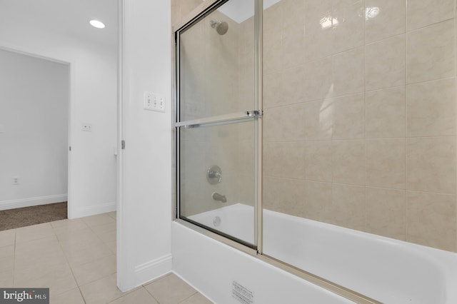 bathroom featuring tile patterned floors and shower / bath combination with glass door