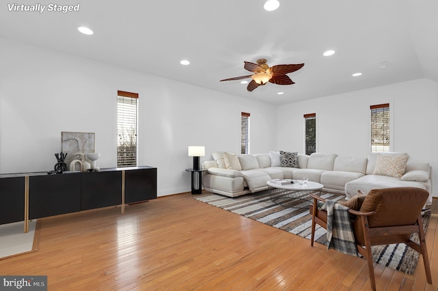 living room with ceiling fan and light hardwood / wood-style floors