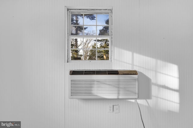 interior details with an AC wall unit and wooden walls