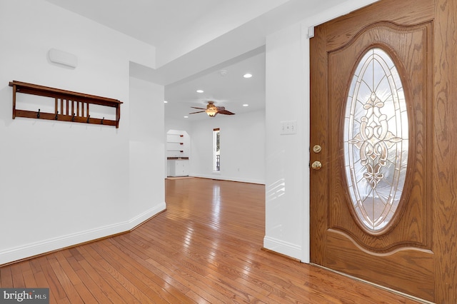 foyer entrance featuring ceiling fan and light wood-type flooring