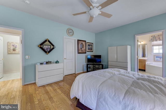 bedroom featuring light hardwood / wood-style flooring, ceiling fan, and ensuite bathroom