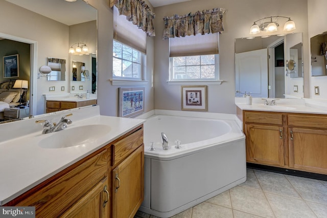 bathroom with a bathing tub, tile patterned flooring, and vanity