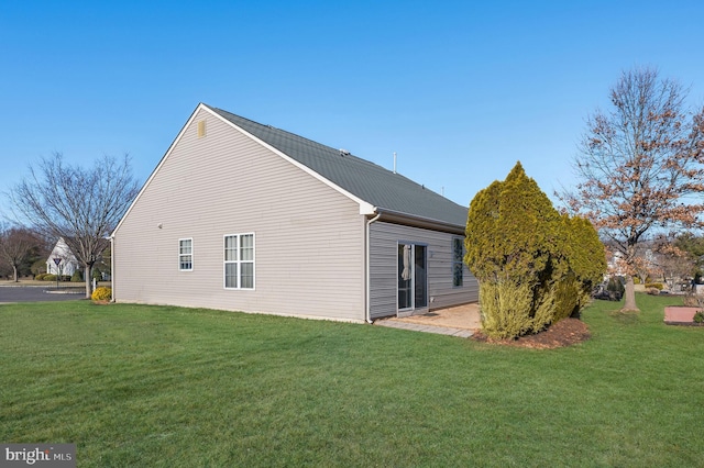 view of home's exterior with a yard