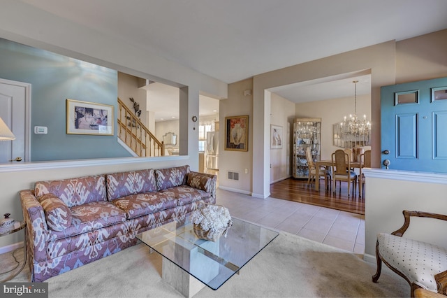 living room featuring light tile patterned floors and a notable chandelier