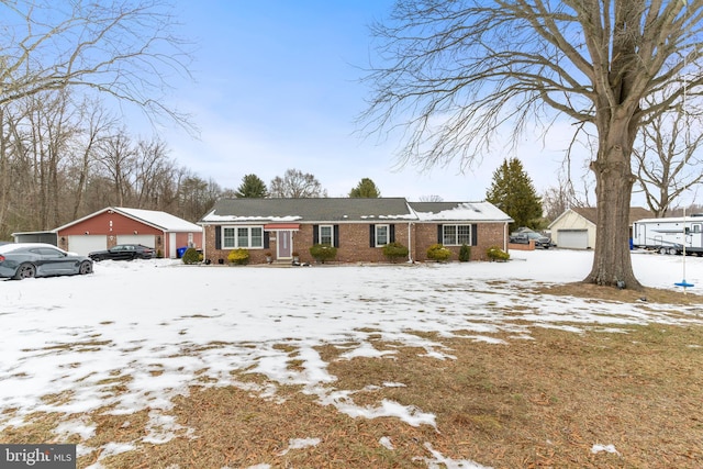 ranch-style home featuring a garage and an outbuilding