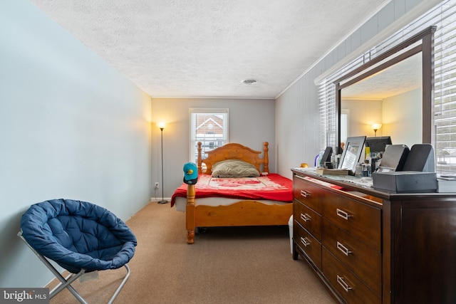 bedroom featuring a textured ceiling and carpet flooring