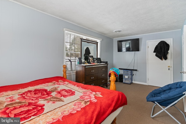 bedroom with a textured ceiling, carpet flooring, and ornamental molding