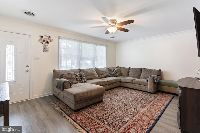 living room featuring ceiling fan, crown molding, and hardwood / wood-style flooring