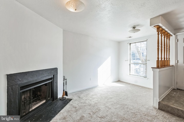 unfurnished living room with a textured ceiling and carpet