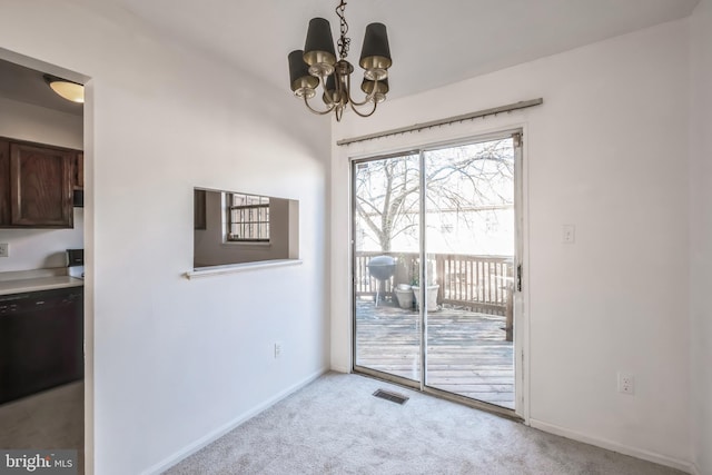 entryway with an inviting chandelier and light carpet