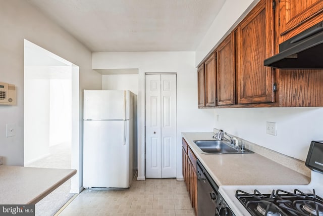 kitchen with white refrigerator, gas stove, dishwasher, and sink