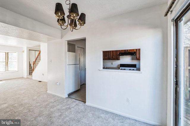 interior space featuring light colored carpet and a chandelier