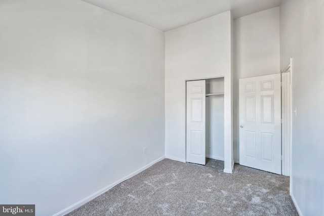 unfurnished bedroom with carpet floors and a closet