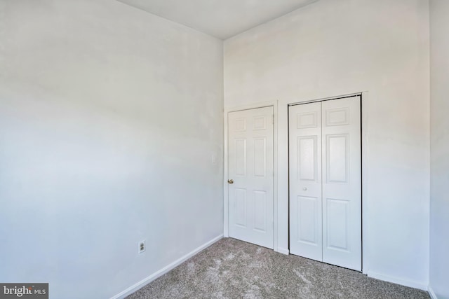 unfurnished bedroom featuring a closet and carpet