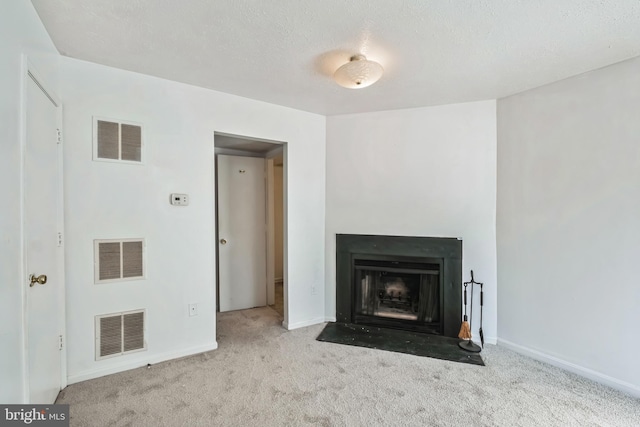 unfurnished living room featuring light carpet