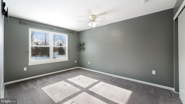 carpeted spare room with ceiling fan