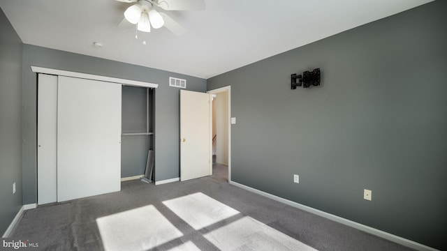 unfurnished bedroom featuring a closet, ceiling fan, and dark carpet