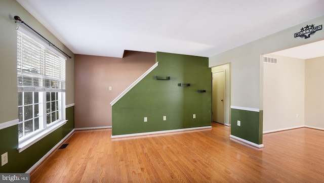 spare room with light hardwood / wood-style flooring