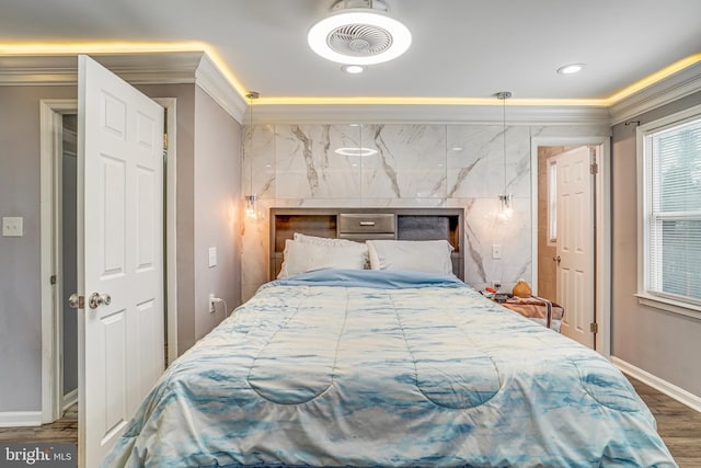 bedroom with ornamental molding and dark hardwood / wood-style flooring