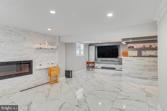 living room featuring a stone fireplace and ornamental molding