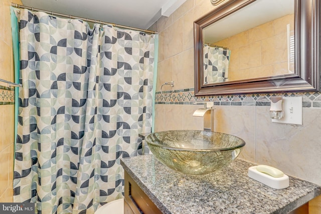 bathroom featuring a shower with curtain, vanity, and tile walls