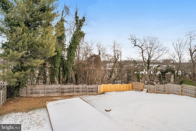 view of yard layered in snow