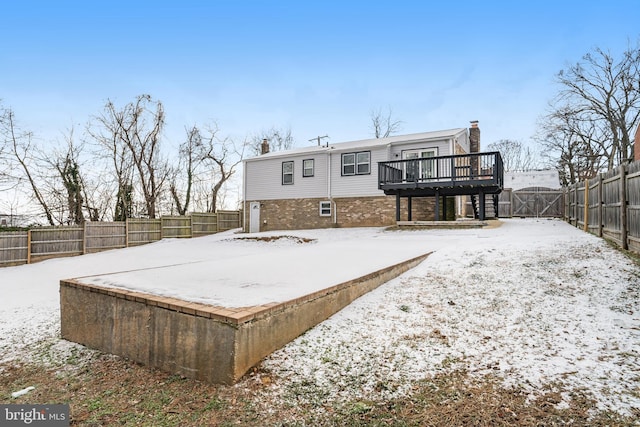 snow covered property with a wooden deck