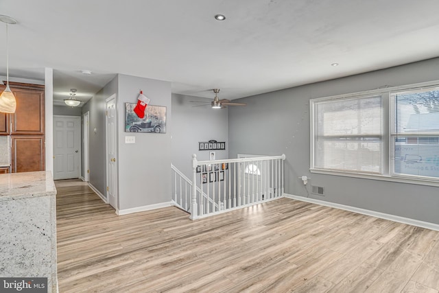 spare room with ceiling fan and light hardwood / wood-style flooring