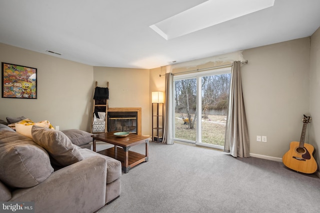 carpeted living room with a skylight