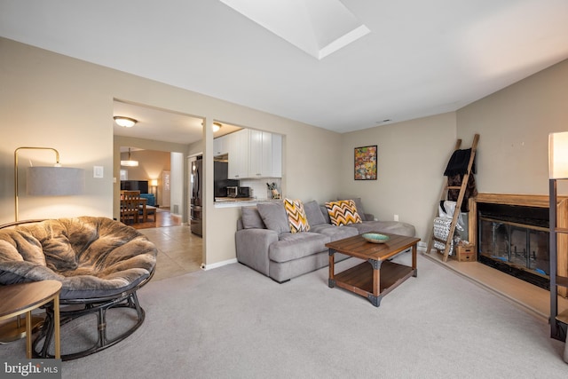 carpeted living room with a skylight