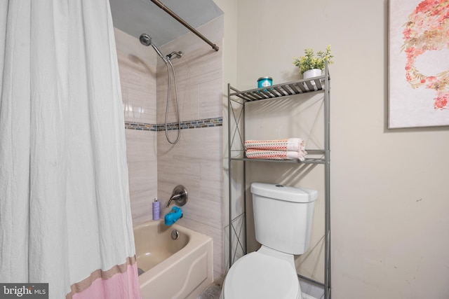 bathroom featuring shower / bath combination with curtain and toilet