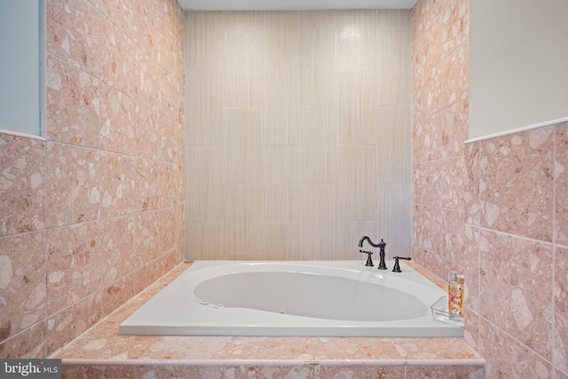 bathroom with tiled bath and tile walls