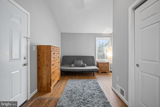 sitting room featuring hardwood / wood-style flooring and vaulted ceiling