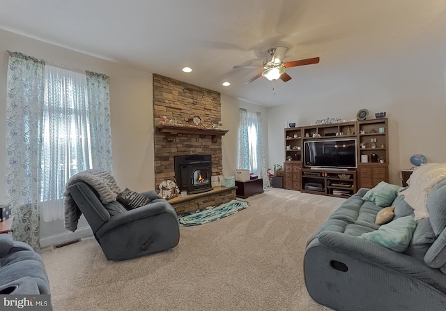 living room with a healthy amount of sunlight, light carpet, and ceiling fan