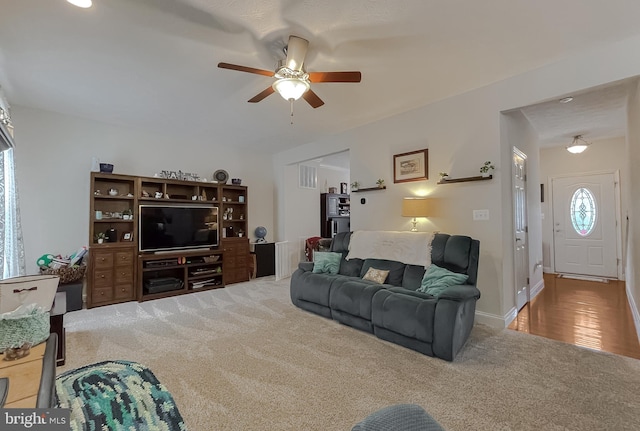 carpeted living room featuring ceiling fan