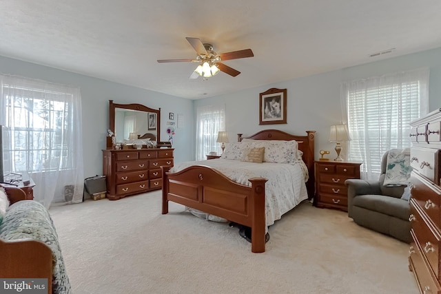 bedroom with light colored carpet and ceiling fan