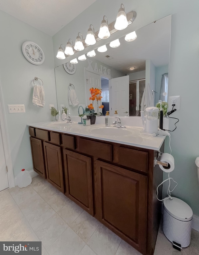 bathroom with vanity, an enclosed shower, and tile patterned flooring