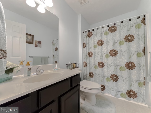 bathroom with vanity, toilet, and tile patterned flooring