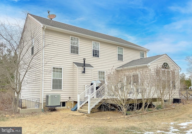 back of house featuring cooling unit and a wooden deck