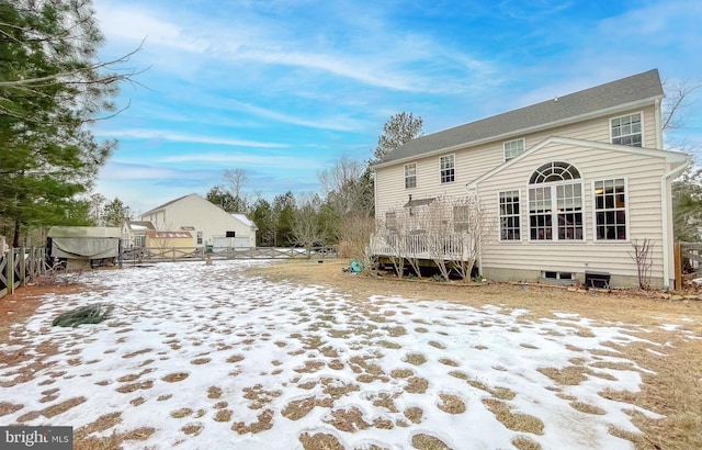 view of snow covered back of property