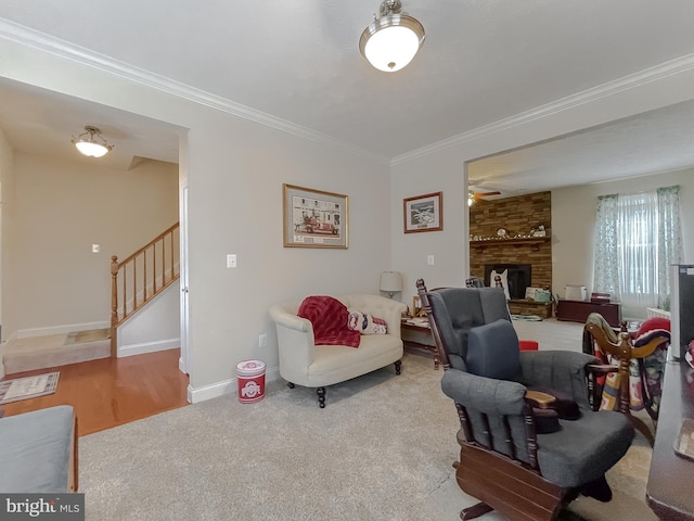 carpeted living room with crown molding and a fireplace