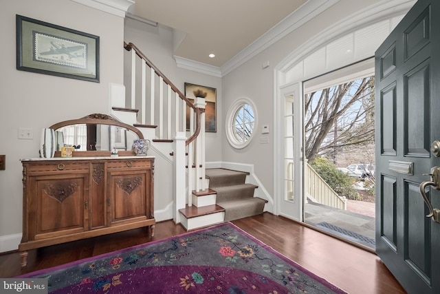 entrance foyer featuring dark wood finished floors, crown molding, stairway, and baseboards